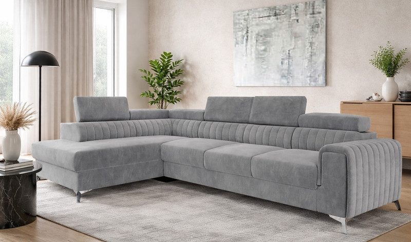 Light grey Fairhaven Long corner sofa bed with channel-stitched arms and adjustable headrests, chaise on the left, on a grey rug in a bright living room