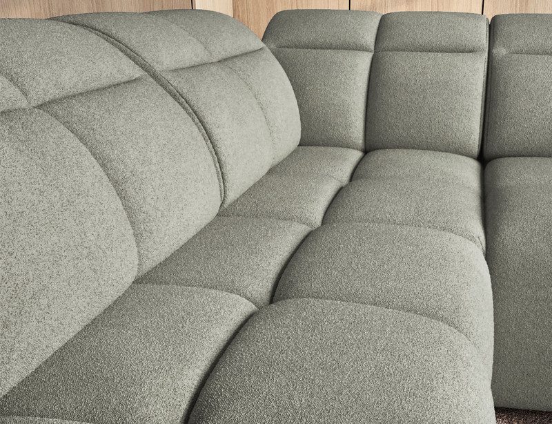 Close-up of the sage green textured fabric on the Lindorf corner sofa's padded seats and backrests, showing the seams between the cushion sections
