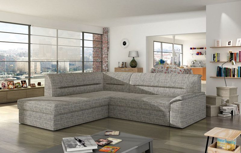 Grey and white woven Zanetta corner sofa bed with the chaise on the left, in an open-plan living room with tall windows and a low grey coffee table