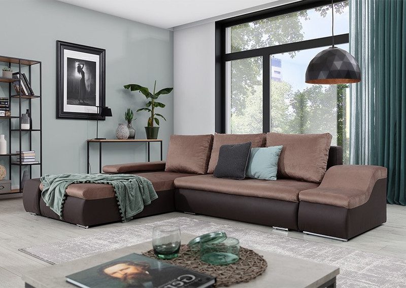 Two-tone brown Jessamine corner sofa bed with a sage green throw over the chaise on the left, charcoal and duck-egg cushions, a grey rug and a black pendant light